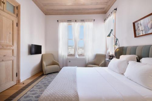 a bedroom with a large white bed and a window at Nars Ilica Hotel Beach Adults Only 12Plus in Cesme