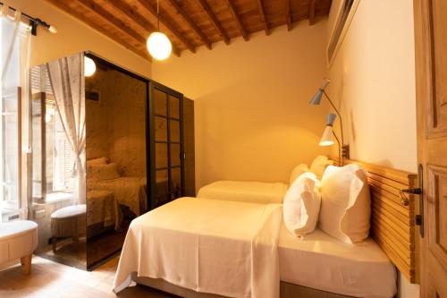 a bedroom with a bed with white sheets and a window at Nars Ilica Hotel Beach Adults Only 12Plus in Cesme
