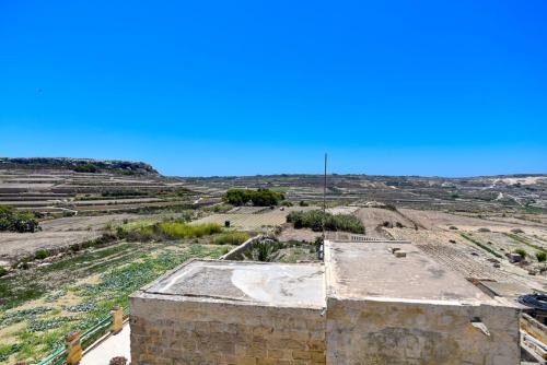 an aerial view of an old building in a field at Azure W B&B in San Lawrenz