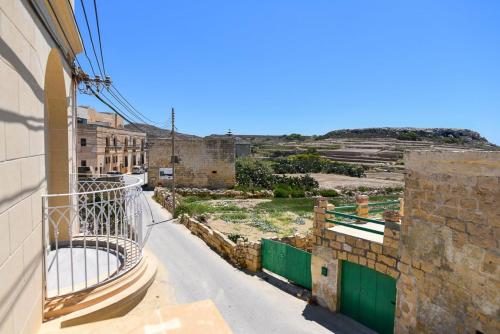 an empty street in an old city with buildings at Azure W B&B in San Lawrenz