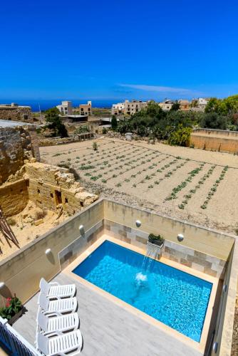 a swimming pool on top of a building at Azure W B&B in San Lawrenz