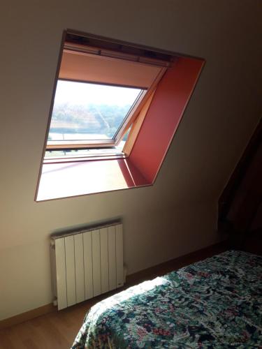 a window in a bedroom with a bed at Chambre d'hôtes chez CBL déco une pause charmante en normandie in Saint-Germain-des-Essourts