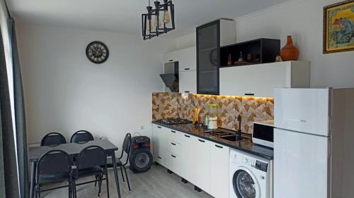a kitchen with a refrigerator and a table and a stove at Mountain flower cottage in Stepantsminda