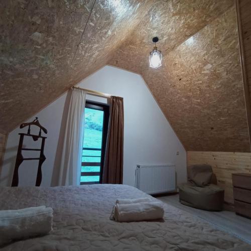 a bedroom with a bed and a window at Mountain flower cottage in Stepantsminda