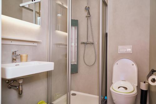 a bathroom with a toilet and a sink and a shower at UplandParcs Sauerland in Winterberg