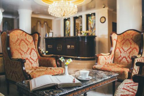 a living room with two chairs and a table with a book at Svityaz Resort in Truskavets