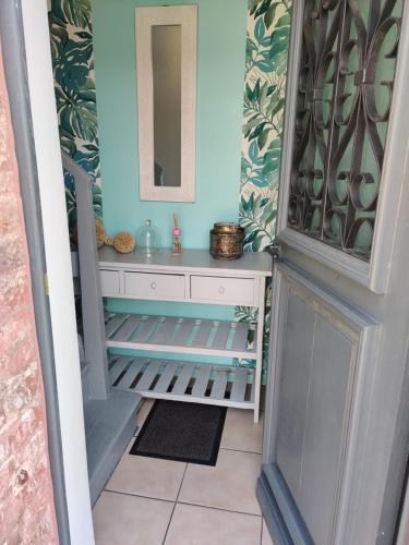 a bathroom with a sink and a mirror at L'Aventurine in Bonnières-sur-Seine
