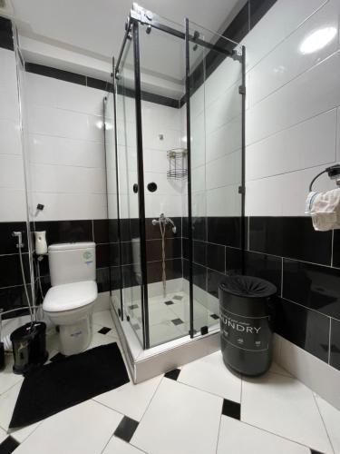 a bathroom with a glass shower and a toilet at Most Beautiful Apartment in Safi in Safi