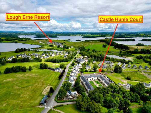 an aerial view of a town with a lake and houses at Escape Ordinary at Castle Hume in Enniskillen