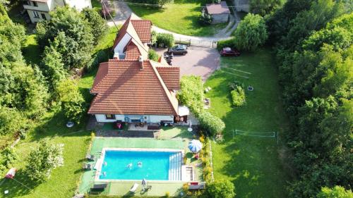 an aerial view of a house with a swimming pool at Podelniska in Porąbka