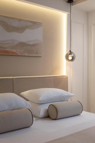 two pillows on a bed with a painting on the wall at Le Prestige Luxury Rooms , Self Check-In, Minutes from Split Waterfront in Split