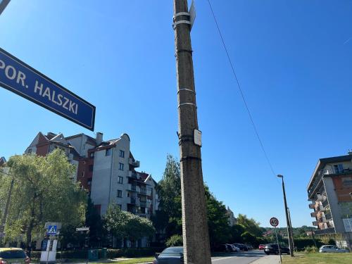 a street sign on a pole on a city street at Halszki Flat in Krakow