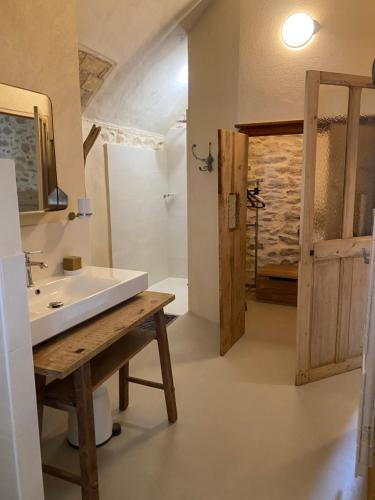 a bathroom with a white sink and a shower at Eden - Mas de Rousseau in Eyragues