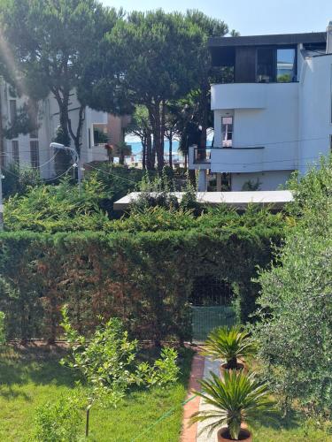 a garden with plants and a building in the background at Villa Pearl Adriatic Coast 2 in Golem