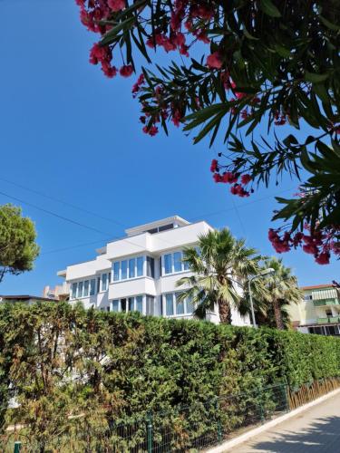 a white building with trees in front of it at Villa Pearl Adriatic Coast 2 in Golem