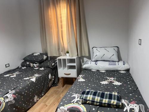 two beds in a small room withskirts at شقة فاخرة في كمبوند ميامى جراند بلازا الإسكندرية in Alexandria