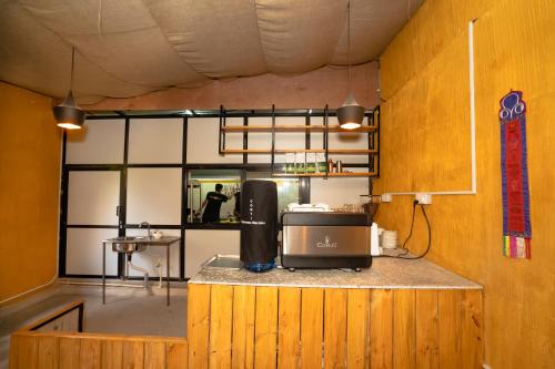 a kitchen with a counter with a microwave on it at Kwabahal Boutique Hostel in Kathmandu