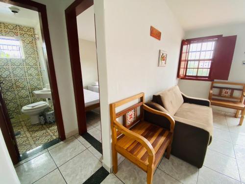 a living room with a couch and a bathroom at Casa Mestre Ataíde in Ouro Preto