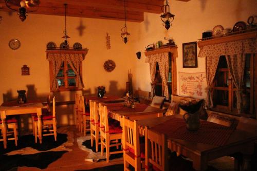 a dining room with wooden tables and chairs at Drevenica in Oščadnica