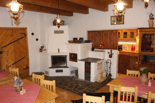 a kitchen with a stove and a table with chairs at Drevenica in Oščadnica
