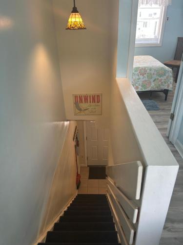 a staircase in a house with a sign on the wall at Sands Townhouses in Old Orchard Beach