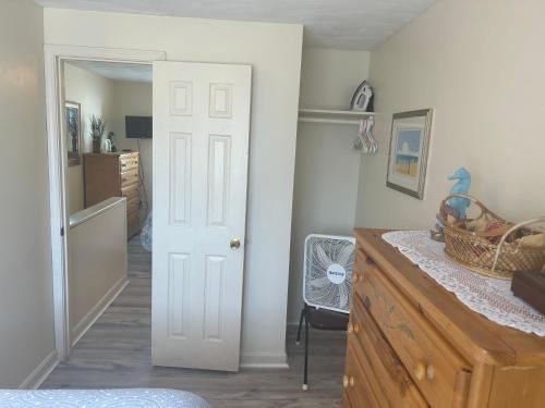 a kitchen with a white door and a counter top at Sands Townhouses in Old Orchard Beach