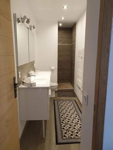 a bathroom with a white sink and a toilet at La Petite Chapelle in Font-Romeu