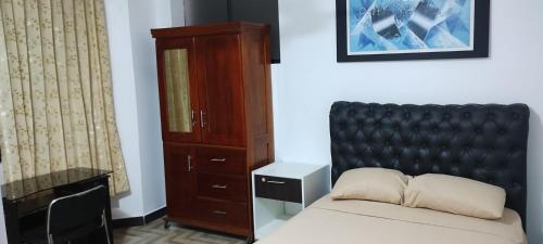 a bedroom with a bed and a cabinet at Makasai Tambopata 3 in Puerto Maldonado