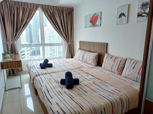 a bedroom with a large bed with two pillows on it at Mansion One Seaview 2Bedroom 2Bathroom Georgetown Gleneagles Penang By AmrayHomes in George Town