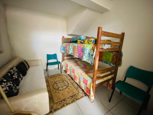 a small bedroom with a bunk bed and a chair at Casa Mestre Ataíde in Ouro Preto