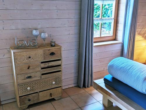 a wooden dresser in a room with a window at Ferienwohnung Blütenzauber in Idyllischer Lage Nähe Bodensee in Hilzingen