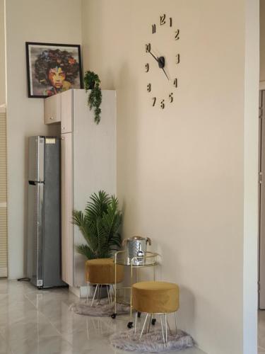 a room with a refrigerator and a table and chairs at Sunset Paradise Home in Discovery Bay