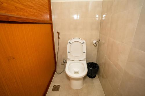 a small bathroom with a toilet in a stall at Kwabahal Boutique Hostel in Kathmandu