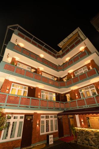 a large building with a balcony on top of it at Kwabahal Boutique Hostel in Kathmandu