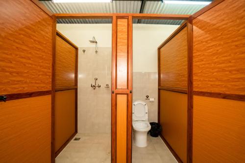 a bathroom with a toilet and a shower at Kwabahal Boutique Hostel in Kathmandu