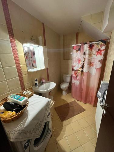 a small bathroom with a sink and a toilet at HIPPOCAMPUS APARTMENT in Stratoni