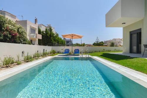 a swimming pool in the backyard of a house at Green Villa in Ialyssos