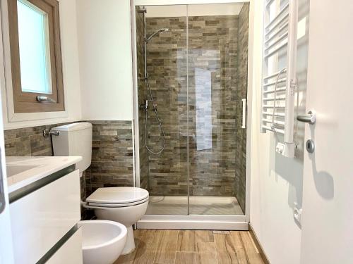 a bathroom with a toilet and a glass shower at Villaggio Camping Valdeiva in Deiva Marina