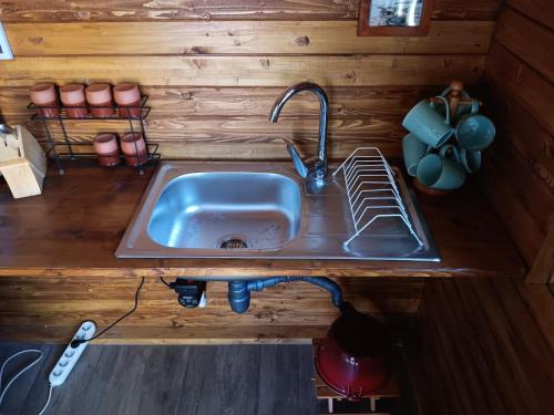 a kitchen with a sink in a tiny house at Camping Curtea Pescărușului in Vama Veche