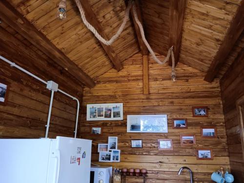 a kitchen with a wooden wall with pictures on it at Camping Curtea Pescărușului in Vama Veche