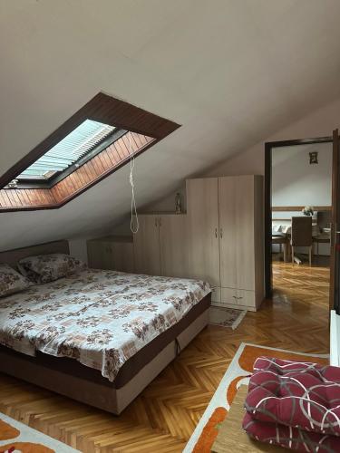 a bedroom with a large bed with a skylight at Attic Baosici in Herceg-Novi