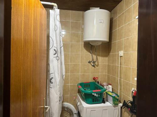 a small bathroom with a toilet and a water tank at Attic Baosici in Herceg-Novi