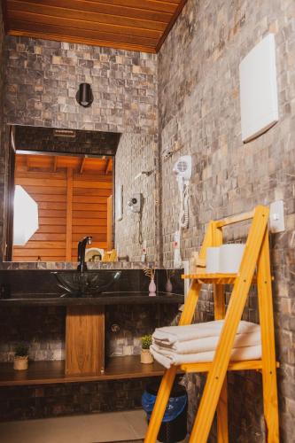 a bathroom with a sink and a mirror at Pousada Gagno in Domingos Martins