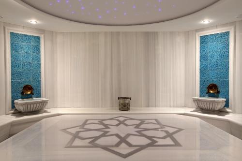 a white room with two vases and two windows at Miracle Istanbul Asia Airport Hotel & Spa in Istanbul