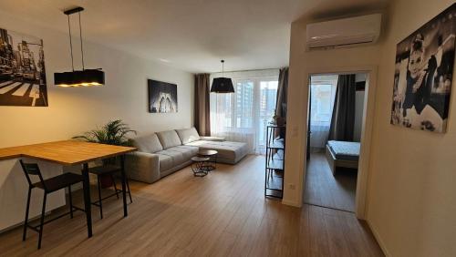 a living room with a couch and a table at 2 room Apartment, with terrace, new building, 210 in Bratislava