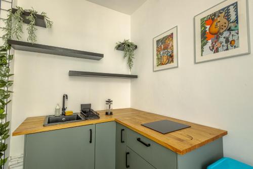 a kitchen with a sink and a wooden counter top at First Hostel in Bucharest