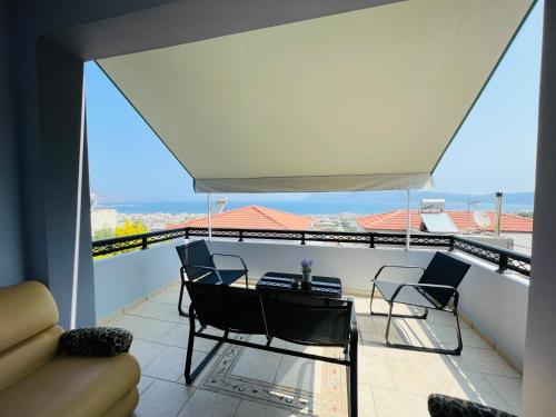 a balcony with chairs and a table with a view at Selini Seaview Villa in Kissamos
