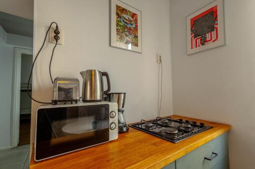 a microwave sitting on a counter next to a stove at First Hostel in Bucharest