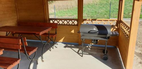 a grill in a room with tables and chairs at Zajazd Stronie in Stronie Śląskie