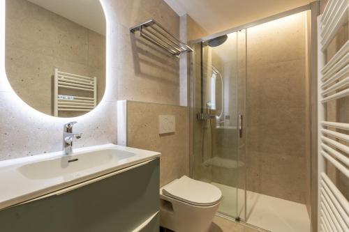 une salle de bain avec un lavabo, des toilettes et une douche dans l'établissement Riante 6 - Appartement proche du village et des pistes, à La Clusaz